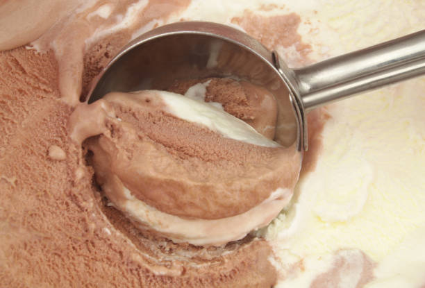 istock Ice-cream scoop on chocolate and vanilla ice creams. 1474551843