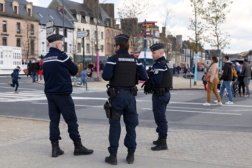 Landerneau, France - April 03 2022: Group of gendarmes monitoring the crowd during the carnival of Landerneau.