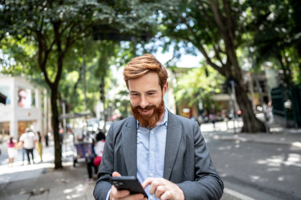 istock Businessman using smartphone outdoors 1474557501