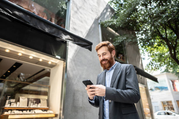 istock Businessman using smartphone outdoors 1474557677