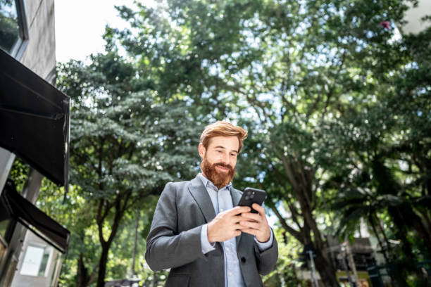 istock Businessman using smartphone outdoors 1474557705