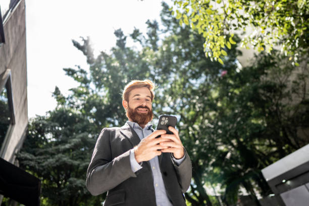 istock Businessman using smartphone outdoors 1474557717
