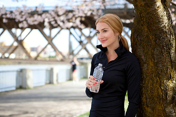 istock Athletic young woman smiles in park 147456854