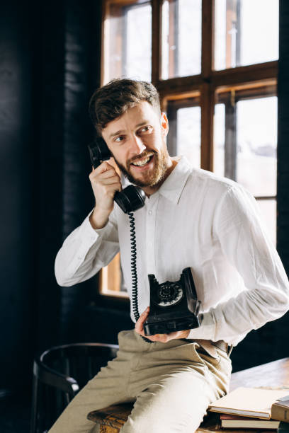istock The handsome man sitting on the working table and answering the phone call 1474568552