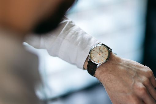 York, United Kingdom - April 27, 2013: Close-up of an expensive Swiss made Breitling chronograph wristwatch. A chronograph is a specific type of watch that is used as a stopwatch combined with a display watch. A basic chronograph has an independent sweep second hand; it can be started, stopped, and returned to zero by successive pressure on the stem. Less simple chronographs use additional complications and can have multiple independent hands to measure seconds, minutes, hours and even tenths of a second. In addition, many modern chronographs use moveable bezels as tachymeters for rapid calculations of speed or distance. Louis Moinet invented the chronograph in 1816 for use in tracking astronomical objects.