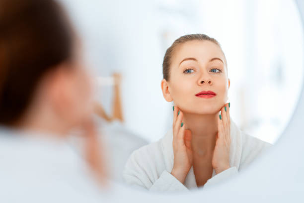 istock woman with cream for her face 1474570851