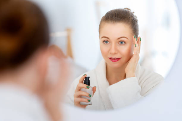 istock woman with cream for her face 1474570877