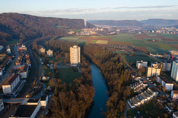 istock Drone snapshot over a small village with a river called Limmat on a spring morning. 1474571318
