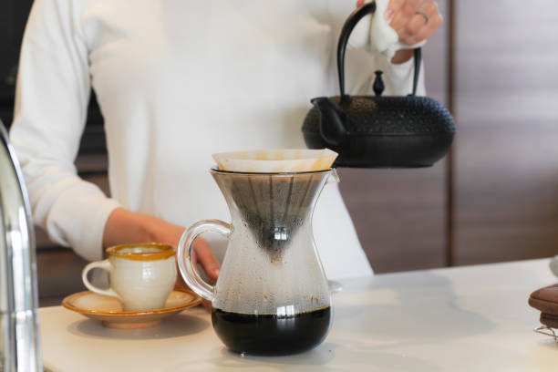 istock A woman brewing coffee in an iron kettle 1474573775