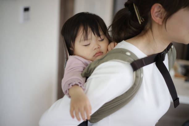 istock mother putting her child to sleep 1474573861