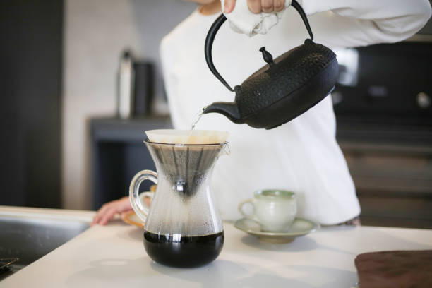istock A woman brewing coffee in an iron kettle 1474574032