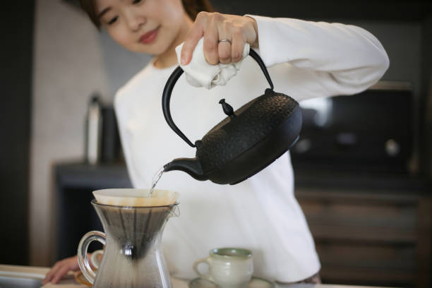 istock A woman brewing coffee in an iron kettle 1474574040