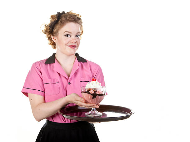 A waitress in a diner passing a customer asking for another coffee refill.