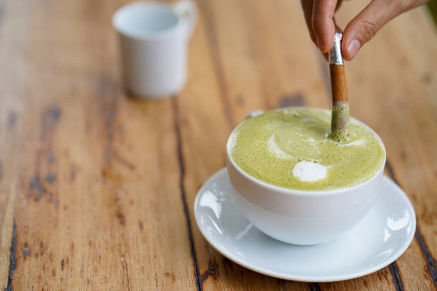 istock Hot green tea served with cinnamon on hand. 1474576688