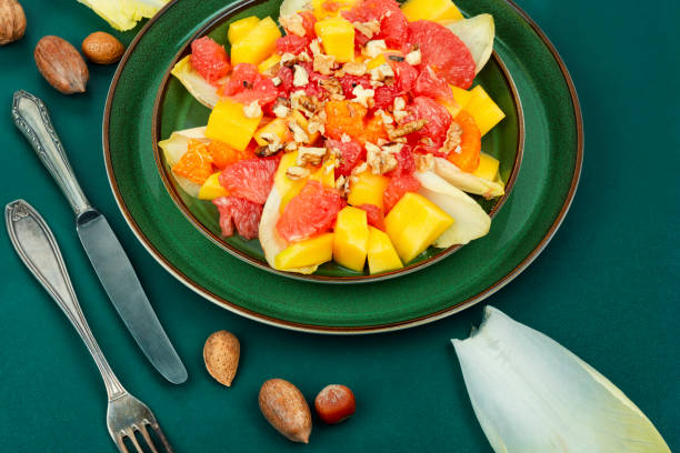 istock Fruit salad of citrus, chicory and nuts. 1474577820