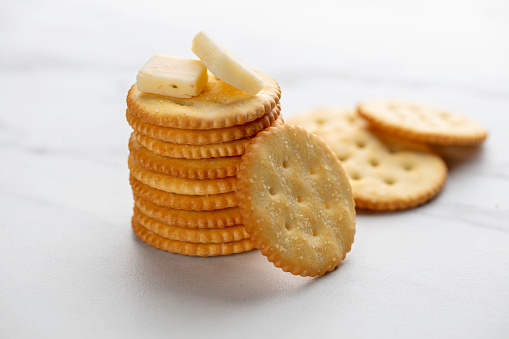 Stack of crackers with cheese on top