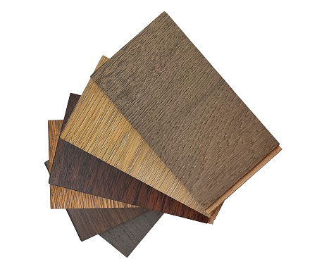 top view of stacked of wooden laminated flooring tiles sample for interior renovation isolated on background with clipping path. engineering floor tiles samples. construction materials.
