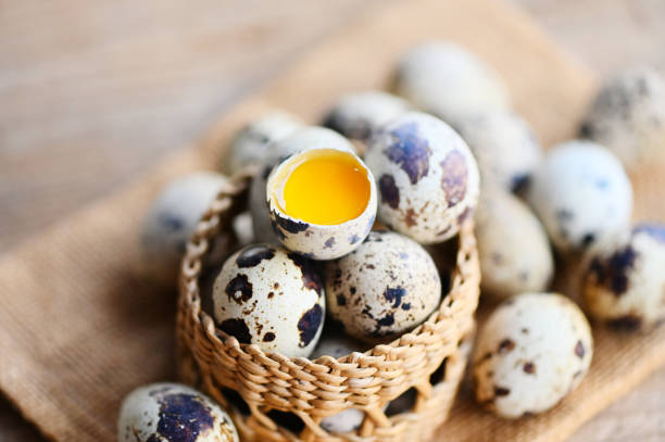 quail eggs on basket, fresh quail eggs on wooden table background, raw eggs with peel egg shell