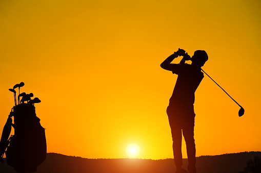 silhouette golfer  beautiful sky backlit sunset background.