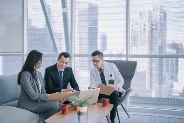 Asian doctors discussion with medical sales representative in doctor's office