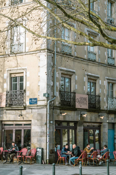 Facade of a typical front of a closed French cafe in Paris during the early morning