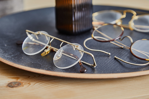 Close-Up Of eyeglasses against orange background.