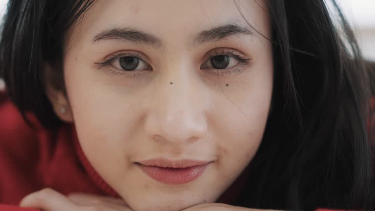 Close up of a Asian woman's eyes and smile. Looking at camera.