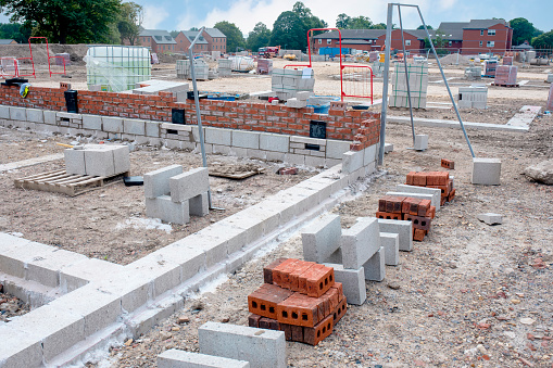 Concrete blocks delivered to construction site and placed next to the place of work and ready for bricklayers