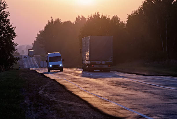 istock trucks travelling on way in the morning 147460078