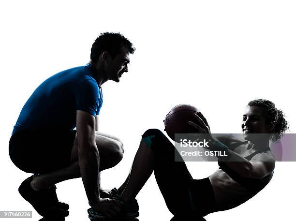 Fitness Trainer Helps Women With Exercise Ball Stock Photo - Download Image Now - White Background, In Silhouette, Back Lit
