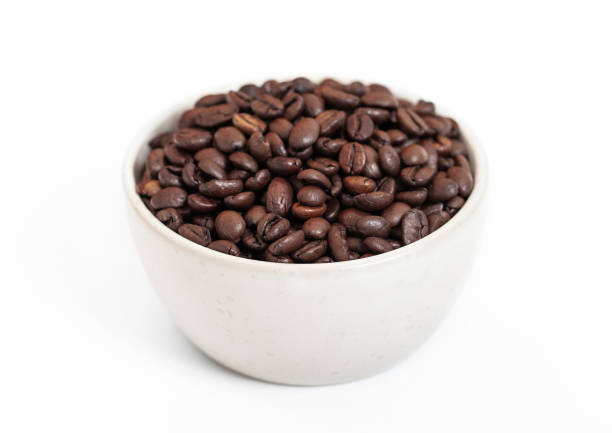 istock Bowl plate with fresh raw aroma coffee beans on white background. 1474603801