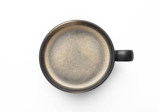 istock Large black coffee in porcelain cup on white background. Top view. 1474603850