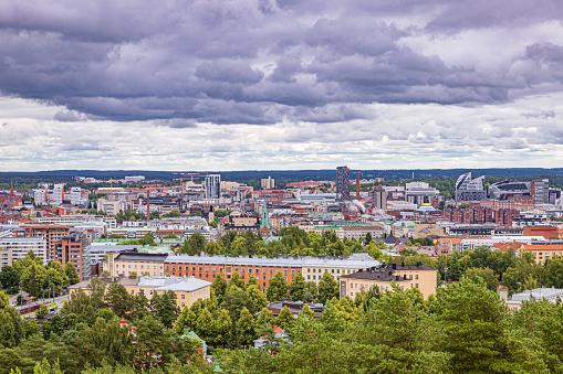 A cloudy summer day in Finland with the views over a forest towards the city center. 1