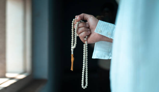 istock Muslim prayer concept image, Hand holding Tasbih 1474605764