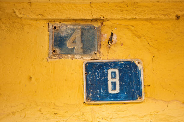 istock Two old Weathered House Numbers on the same entrance, 4 and 8, Tile on Wall 1474610255