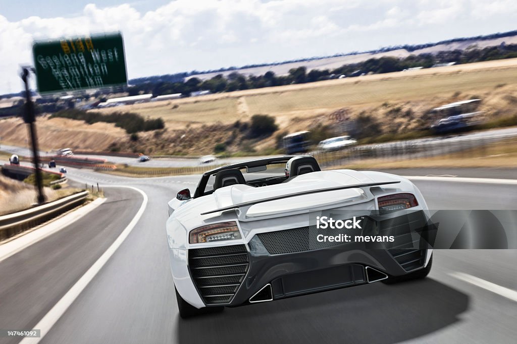Sports Car on Freeway Behind a fast white sports car travelling on along a freeway. The car is designed and modelled by myself. Very high resolution 3D render composite. All markings are ficticious. Sports Car Stock Photo