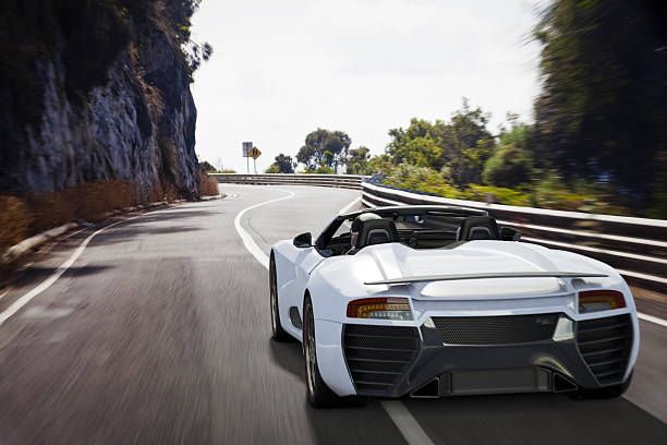 Sports Car on a Coastal Road A white sports car navigating the winding curves of the Great Ocean Road in Victoria, Australia. This car is designed and modelled by myself. Very high resolution 3D render composite. All markings are ficticious. sports car stock pictures, royalty-free photos & images