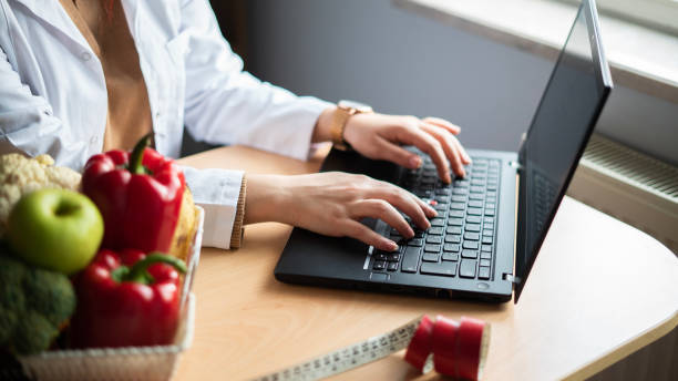 istock Close-up Nutritionist woman using laptop 1474611035