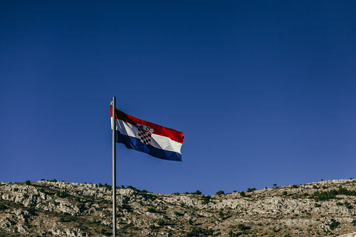 Serbian flag waving on a green background. Horizontal composition with copy space.