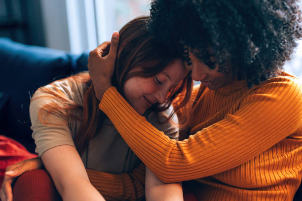 istock multiethnic female partners in harmony bonding with tender affection and hugging at home 1474611936