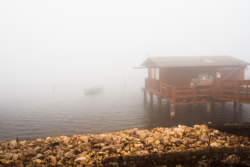 a foggy landscape inside the lagoon of the Delta of the Po River during the winter season, Porto Tolle, Rovigo