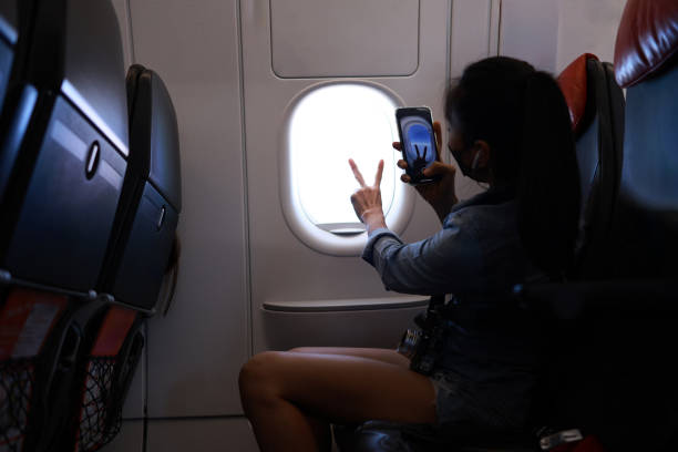istock Female tourist carry a backpack looking at flight schedules for checking take off time. Single woman travel or backpacker theme. Back view portrait. AI generative 1474613388