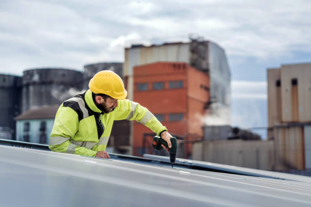 istock Male electrical engineer working at solar power station. Photovoltaic module energy generation 1474613762