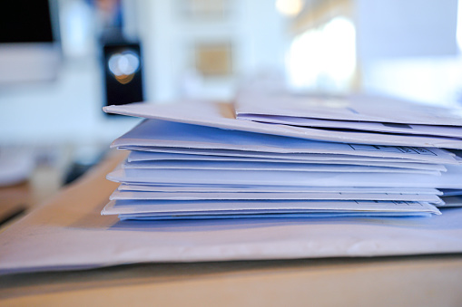 Stack pile of opened envelope documents to read