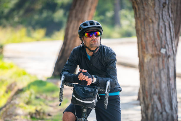 istock Professional cyclist riding bicycle forest on asphalt road 1474616834