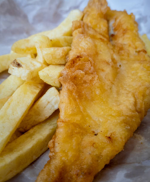 istock Traditional British fish and chips served in paper. 1474619694
