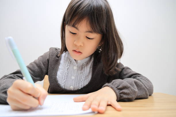 istock Japanese student girl studying in dining room (8 years old) 1474621338