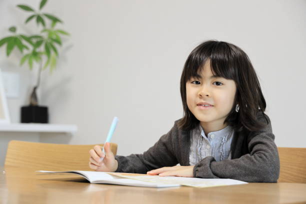 istock Japanese student girl studying in dining room (8 years old) 1474621371
