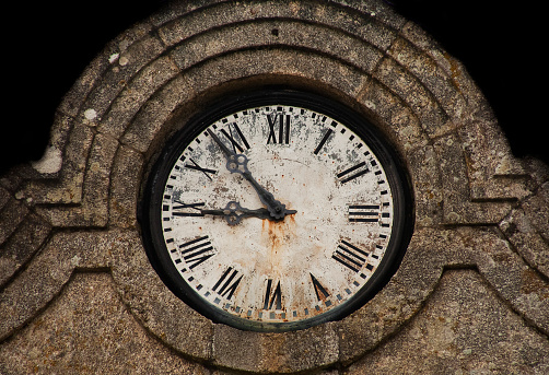 Ancient building, Villamarín town hall in  Ourense province, Galicia, Spain.  building facade close-up view of ruined clock .