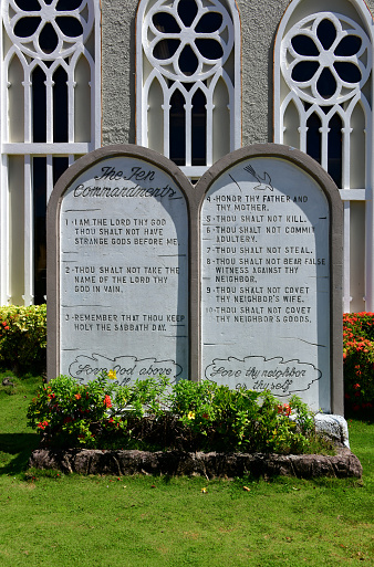 Chalan Kanoa / Charan, Saipan, Commonwealth of the Northern Mariana Islands (CMNI): the Ten Commandments  in two tablets in front of the Catholic Cathedral of Our Lady of Mount Carmel Cathedral. You shall have no other God's before me. Thou shalt not make unto thee any graven images. Thou shalt not take the name of the Lord thy God in vain. Remember the Sabbath day and keep it Holy. Honour your father and mother. Thou shalt not kill. Thou shalt not commit adultery. Thou shalt not steal. Thou shall not bear false witness. You shall not covet.